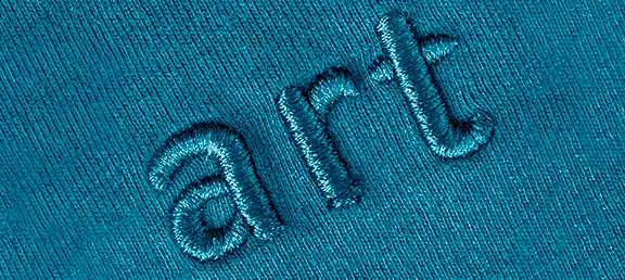 Embroidery on fabric with the word "art" embroidered as an example of good digitizing & vector company output.